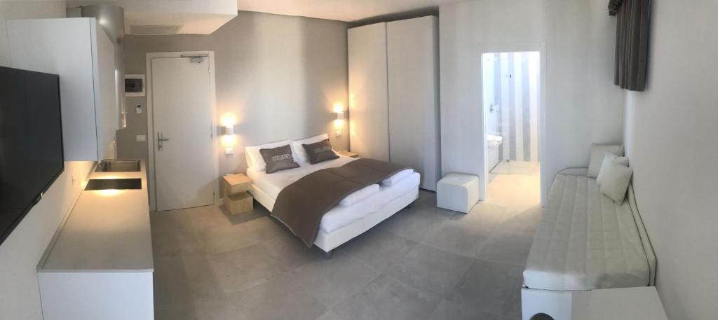a bedroom with a bed and a room with a television at Stellamare in Caorle