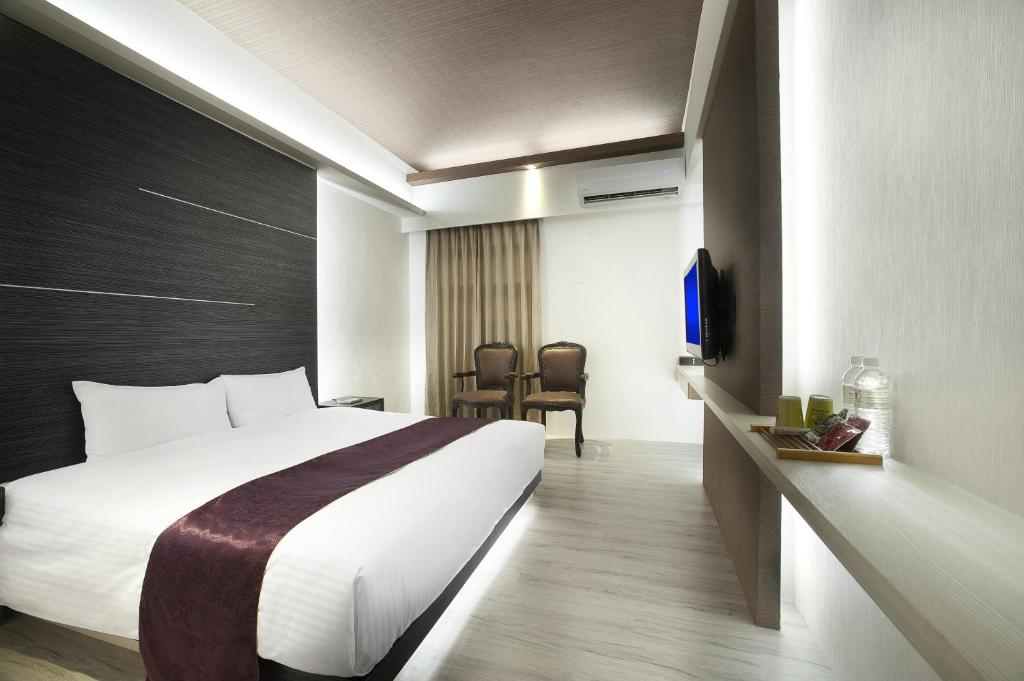 Postel nebo postele na pokoji v ubytování One Fukun Hotel