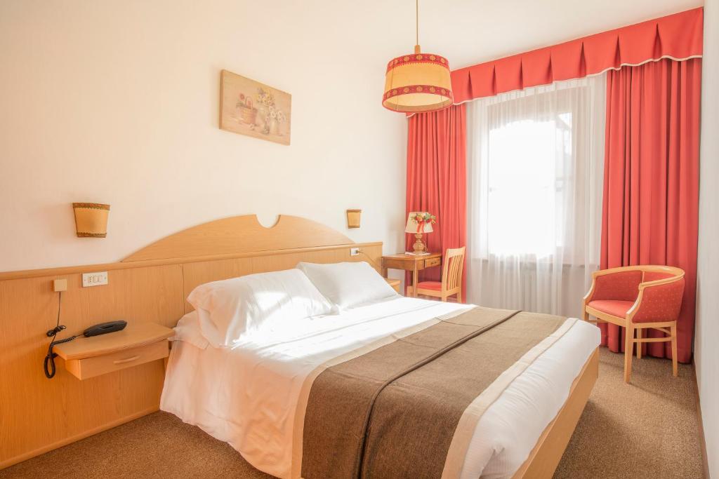 Postel nebo postele na pokoji v ubytování Hotel Villa Trieste