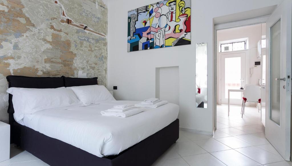 um quarto com uma cama branca e uma pintura na parede em Italianway-Porro Lambertenghi em Milão
