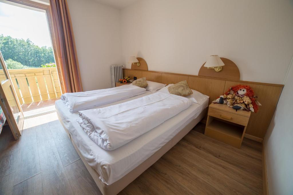Postel nebo postele na pokoji v ubytování Caminetto Mountain Resort