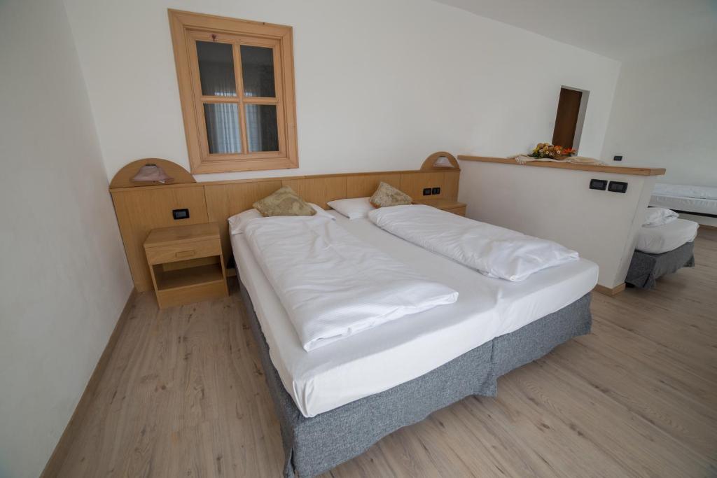 Postel nebo postele na pokoji v ubytování Caminetto Mountain Resort