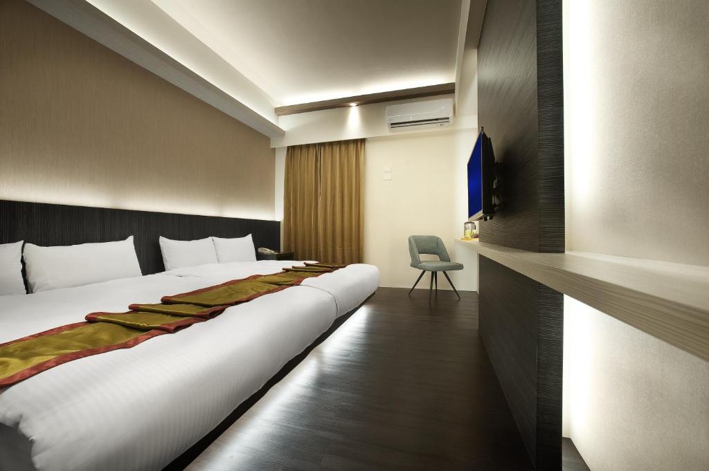 Postel nebo postele na pokoji v ubytování One Fukun Hotel