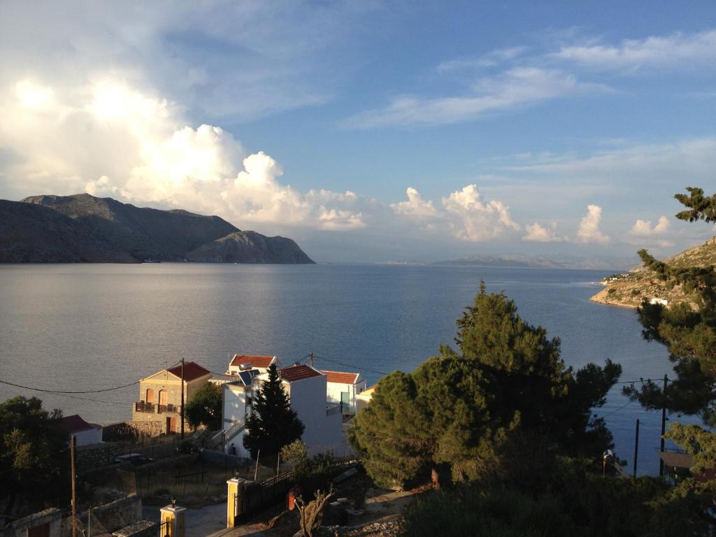 a view of a large body of water with houses at Panorama Thea in Symi