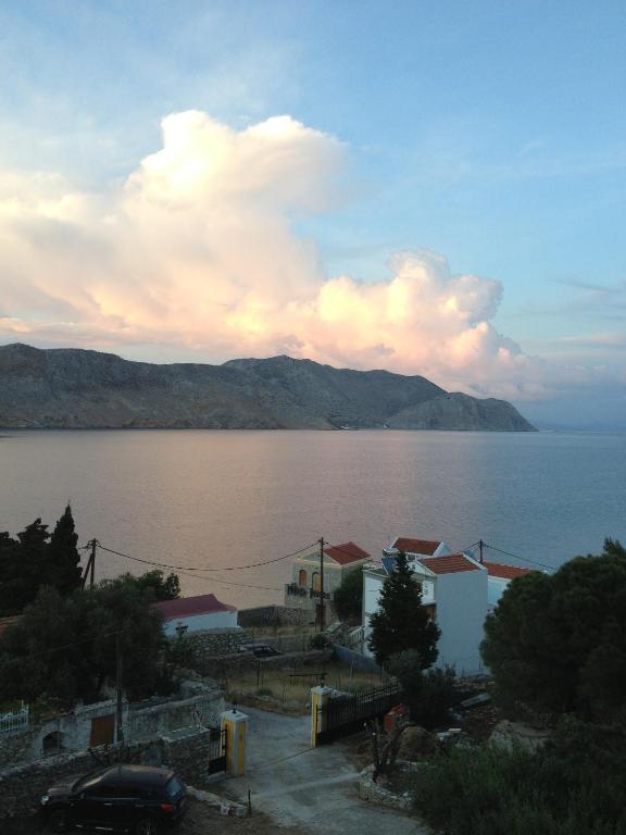 a view of a large body of water with mountains at Panorama Thea in Symi