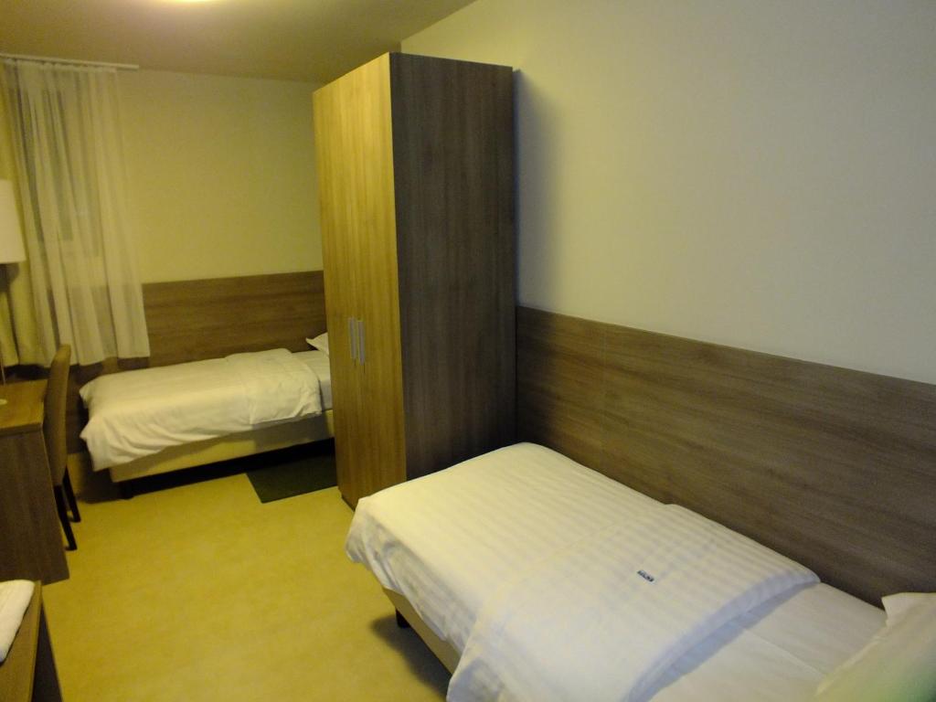 Postel nebo postele na pokoji v ubytování Garni Hotel Zenit