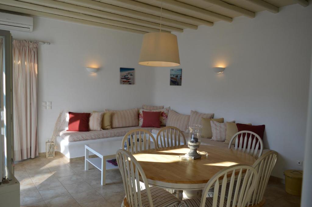 a living room with a table and a couch at Sea Side Studios & Houses in Kalo Livadi