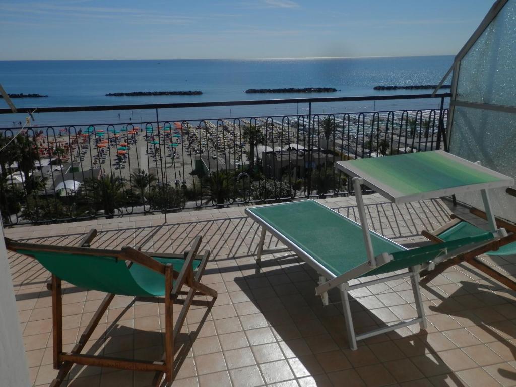 a balcony with a table and chairs and the ocean at B&B Attico Mare in San Benedetto del Tronto