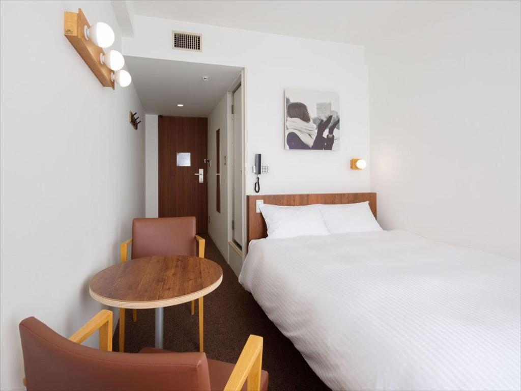 Postel nebo postele na pokoji v ubytování Hotel Plumm