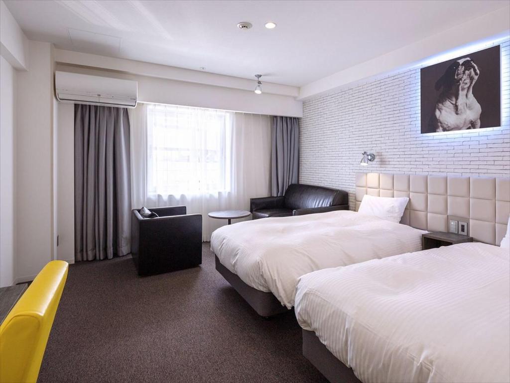 Postel nebo postele na pokoji v ubytování Hotel Plumm