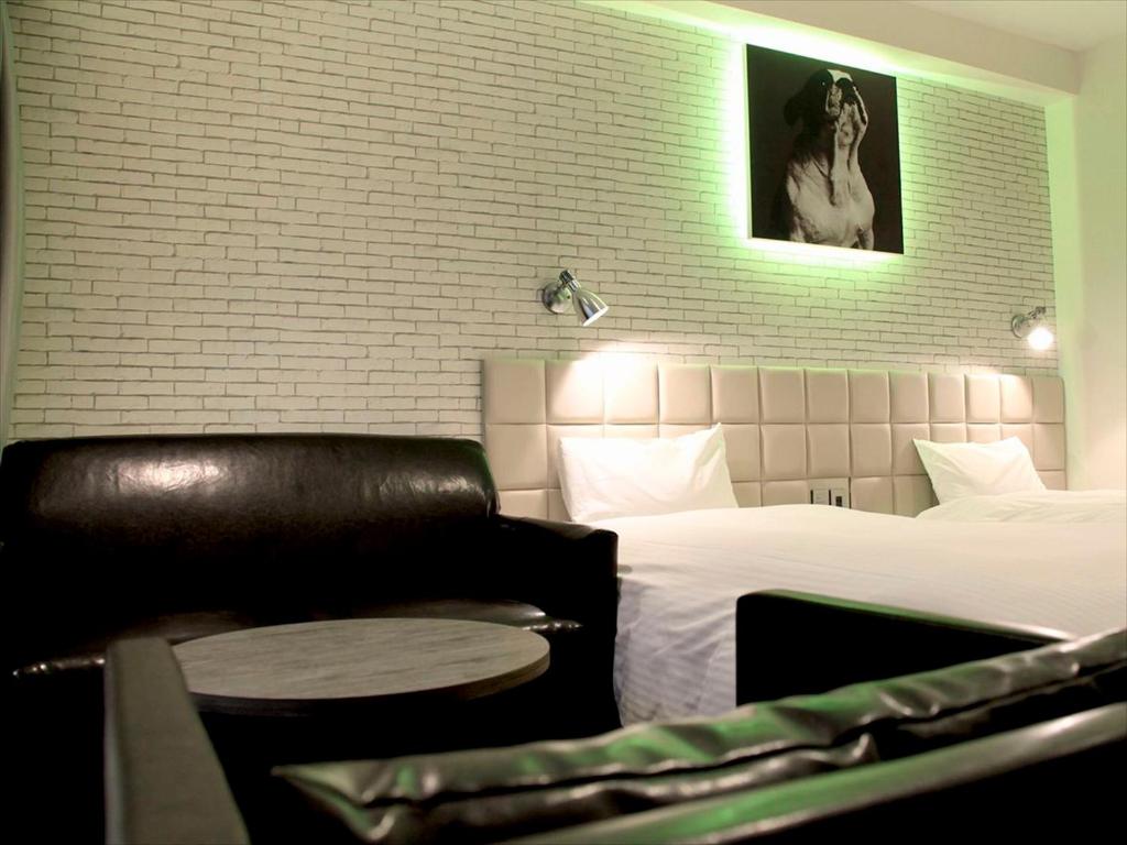 Postel nebo postele na pokoji v ubytování Hotel Plumm