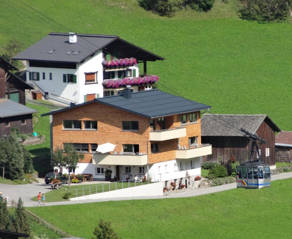 a large building with flowers on the top of it at Appartements Veronika in Silbertal
