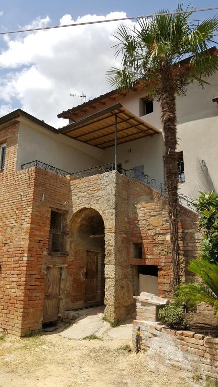 a brick building with a palm tree in front of it at Montevenere 83 in Chiusi