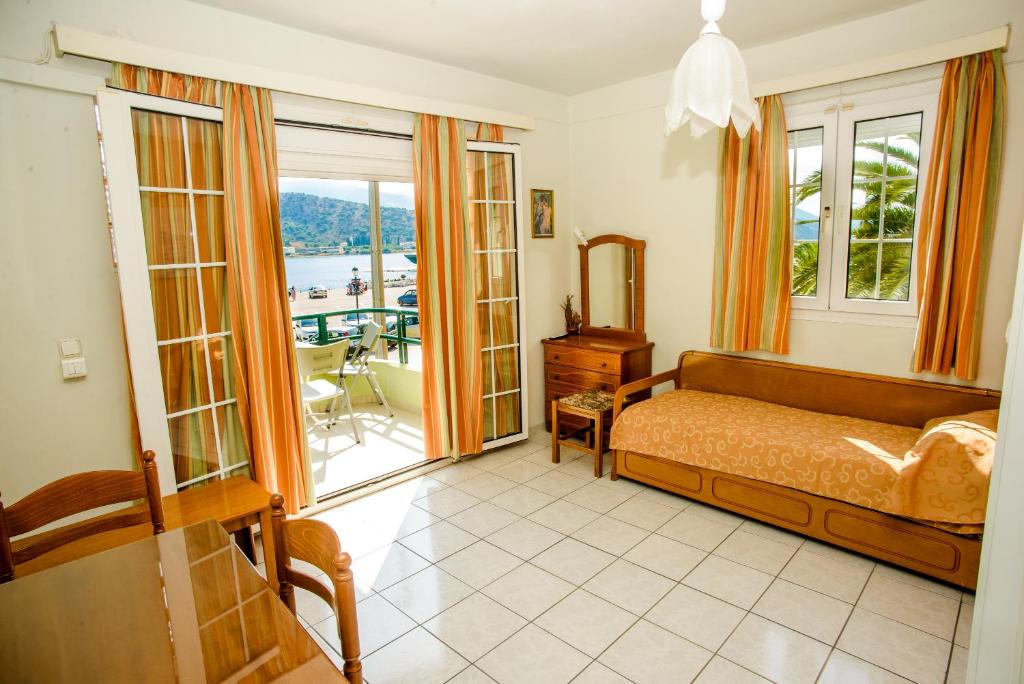 a bedroom with a bed and a balcony at Myros Studios in Argostoli