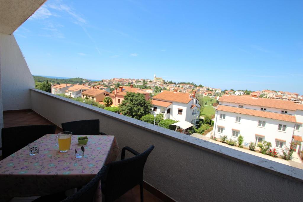a table on a balcony with a view of a city at Apartment Sandi in Vrsar