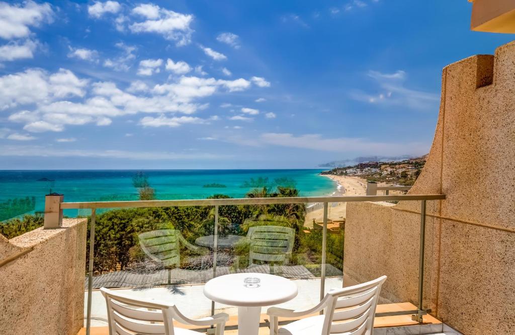 einen Balkon mit einem Tisch und Stühlen sowie Meerblick in der Unterkunft SBH Taro Beach Hotel in Costa Calma