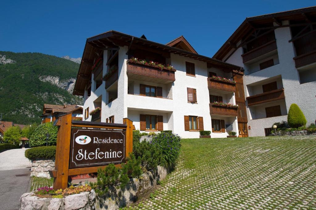 a building with a sign in front of it at Residence Stefenine in Molveno