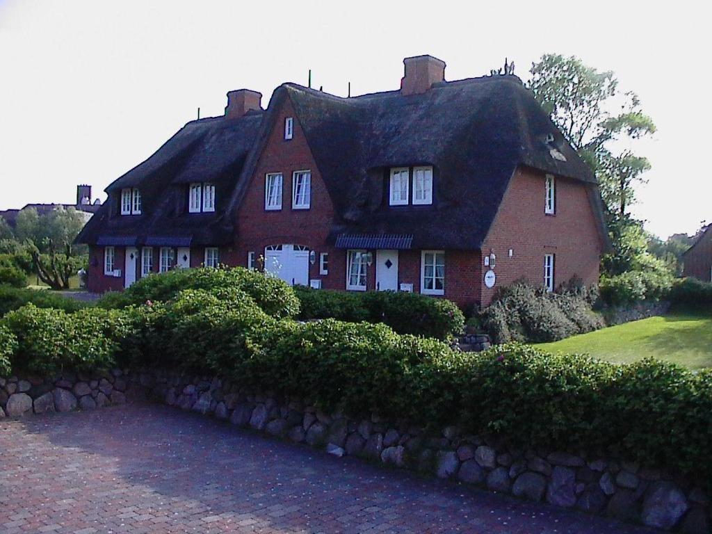 a large red brick house with a black roof at Westhof-3 in List