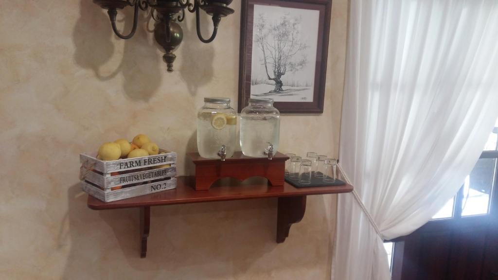a wooden shelf with a jar of fruit on it at El Tejo de Comillas in Comillas