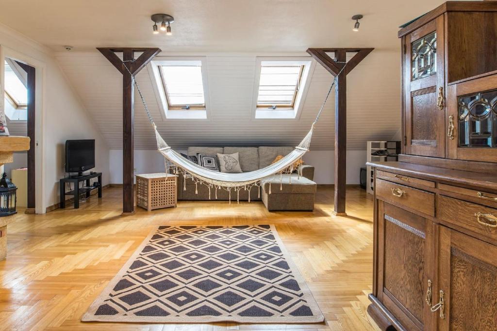 a room with a hammock in the middle of a room at Old Riga Romantic Loft in Riga
