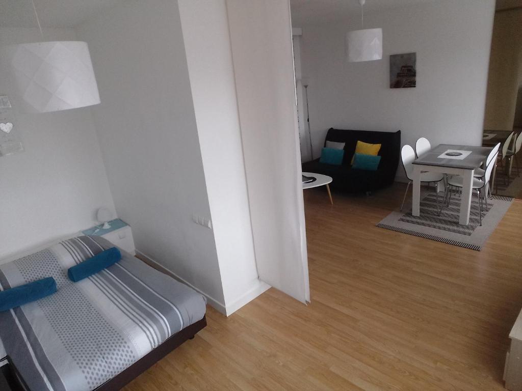 um quarto com uma cama, uma mesa e uma cadeira em Appartement Le Gambetta em Troyes