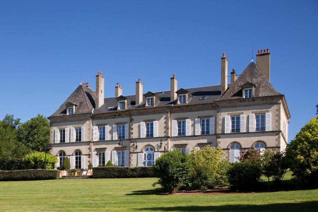 a large house on a grassy field in front at Château d'Ygrande - Teritoria in Ygrande