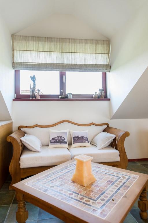 a living room with a couch and a table at Farma Loreta in Vlašim