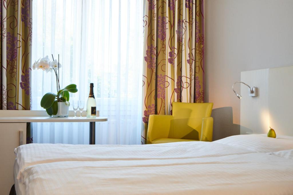 Postel nebo postele na pokoji v ubytování Hotel Concorde