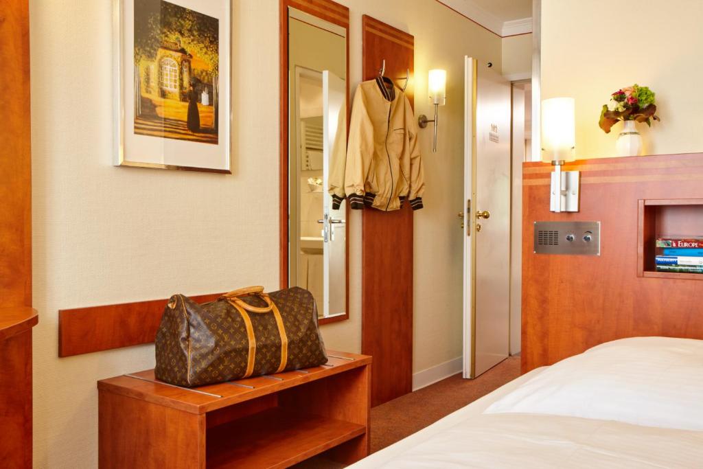 Postel nebo postele na pokoji v ubytování Hotel Concorde