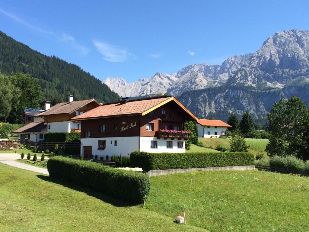 a house in a field with mountains in the background at Haus Karl's Ruh in Ehrwald