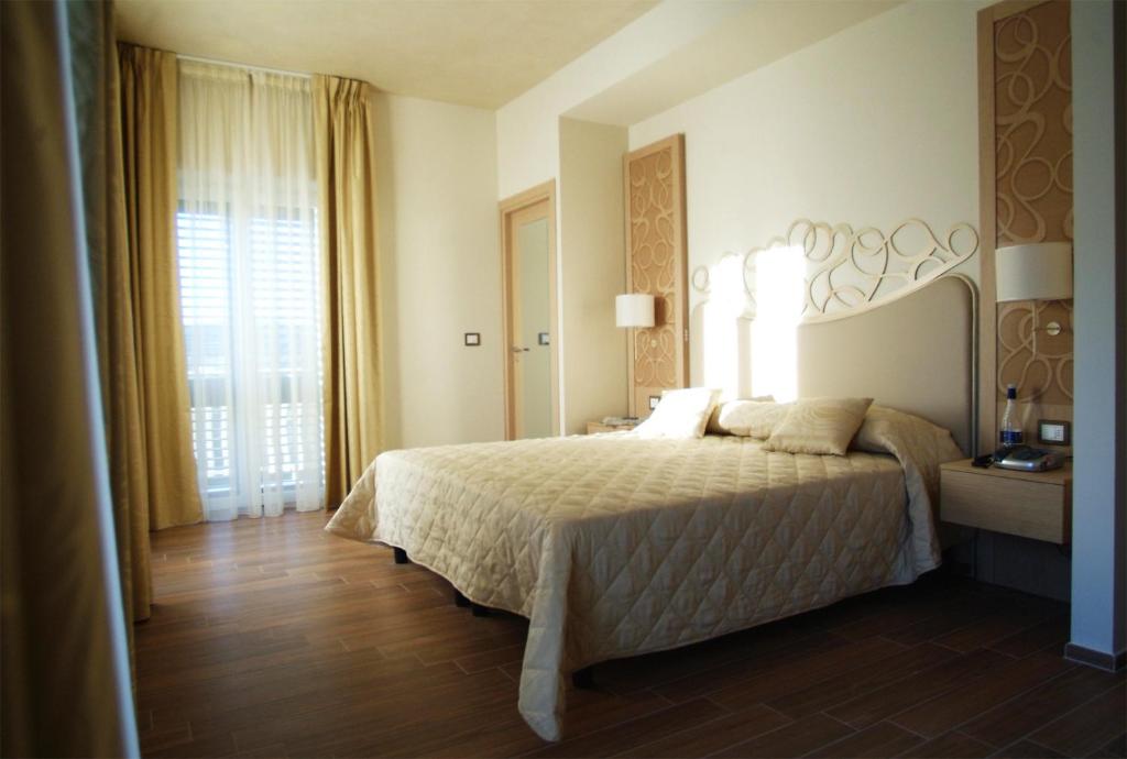 Postel nebo postele na pokoji v ubytování Hotel Duchessa Della Sila