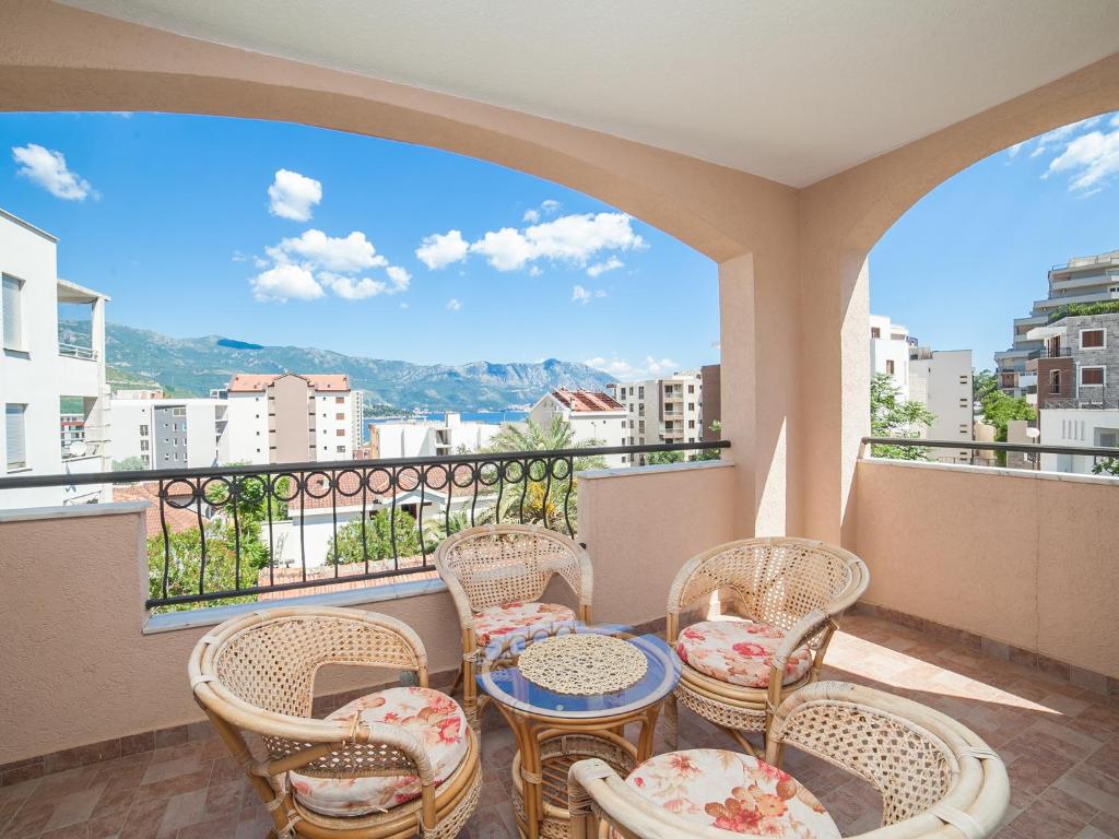 a balcony with chairs and a table with a view at Apartments Spin in Budva