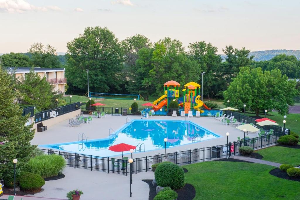 a large swimming pool with a slide in a park at Red Lion Hotel Harrisburg Hershey in Harrisburg