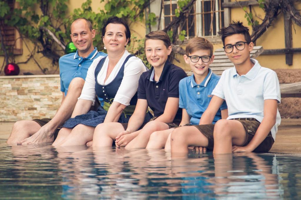 a group of people sitting in the water at Zum Dorfschmied in Klein Sankt Paul