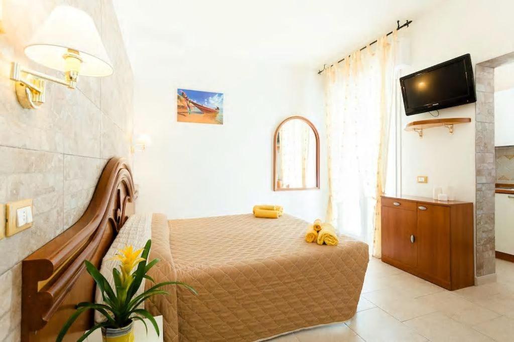 a bedroom with a bed with yellow stuffed animals on it at Residence La Villetta in Rimini