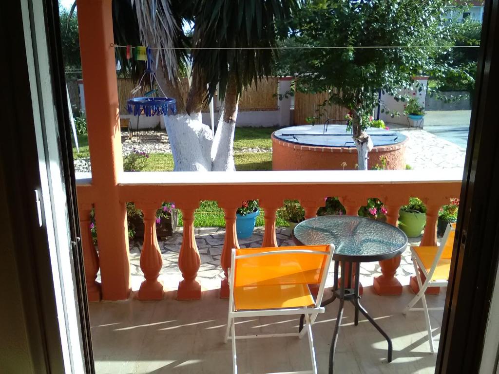 a view of a patio with a table and chairs at Armonia Studios in Agios Georgios