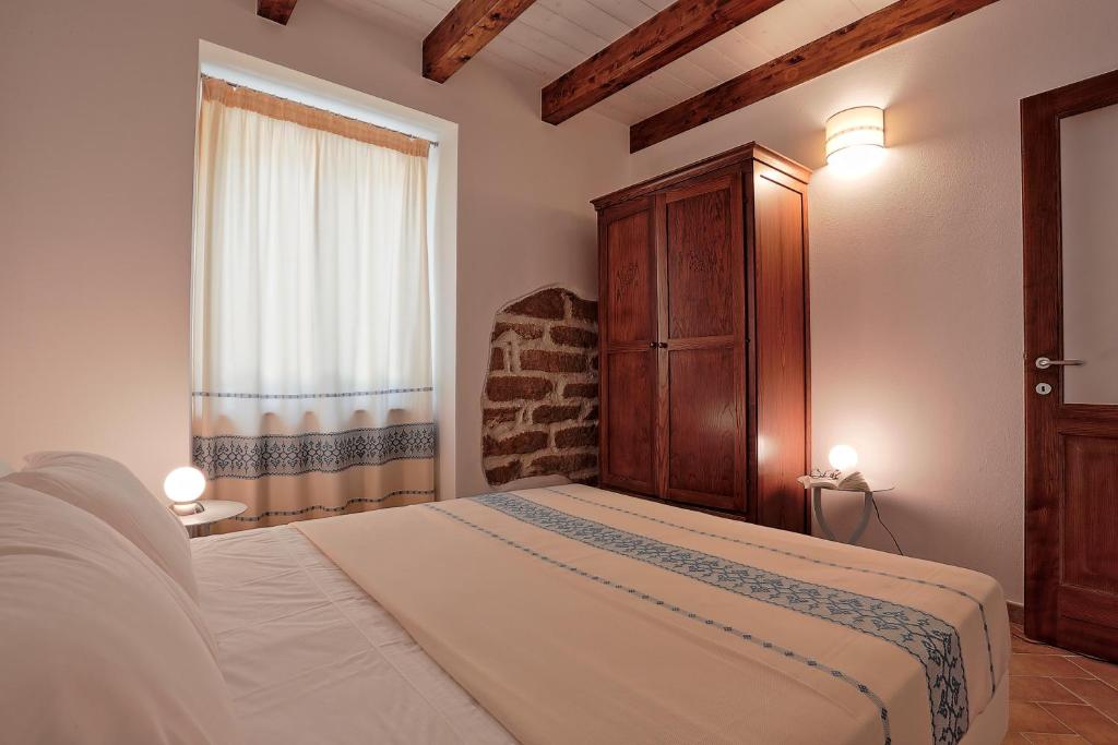 Een bed of bedden in een kamer bij Agriturismo Casale Degli Ulivi Alghero