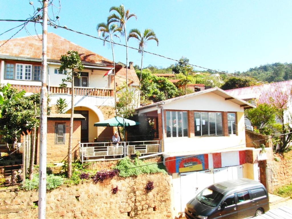 a house with a car parked in front of it at Three Palms Fianar in Fianarantsoa