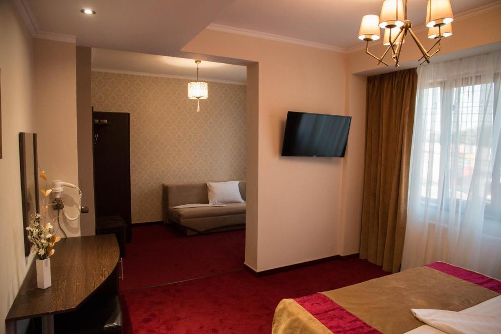 Postel nebo postele na pokoji v ubytování Hotel Ioana