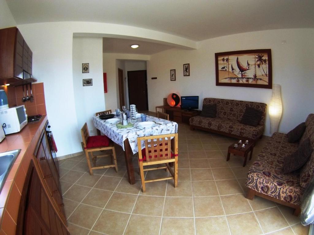 a living room with a table and a couch at Casa Bahia 8 in Santa Maria