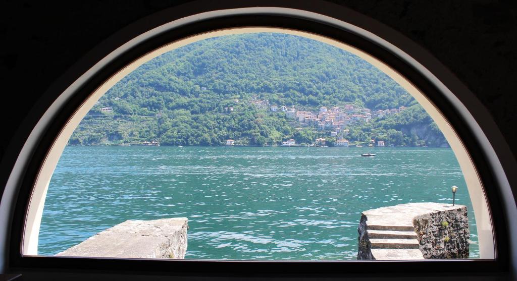 a view of a large body of water through a window at House on the lake shore of Laglio in Laglio