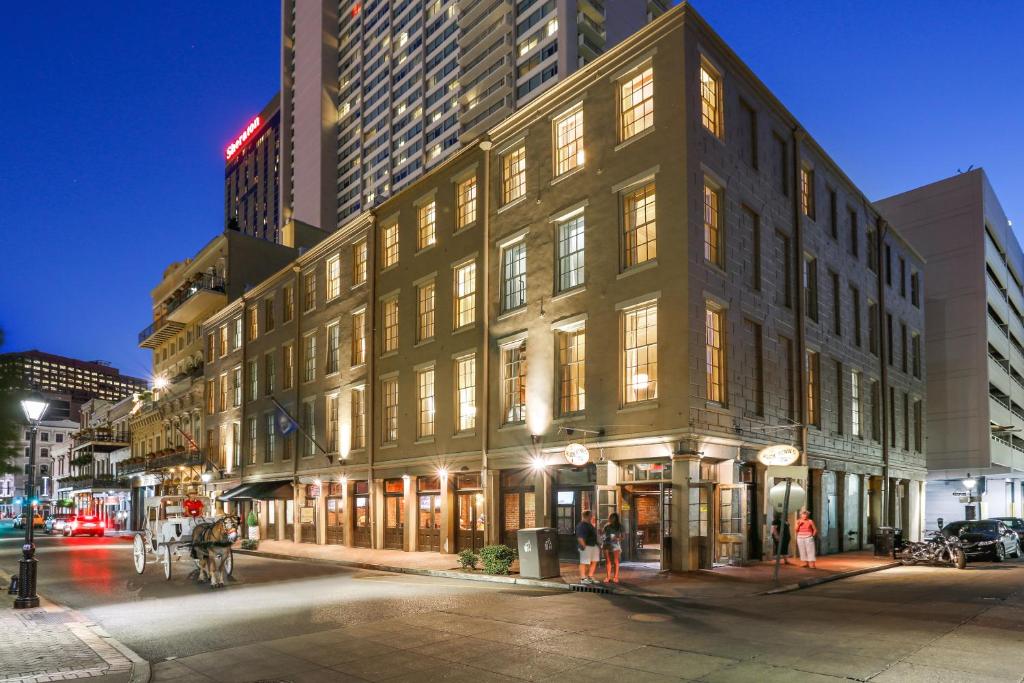a large building on a city street at night at La Galerie French Quarter Hotel in New Orleans