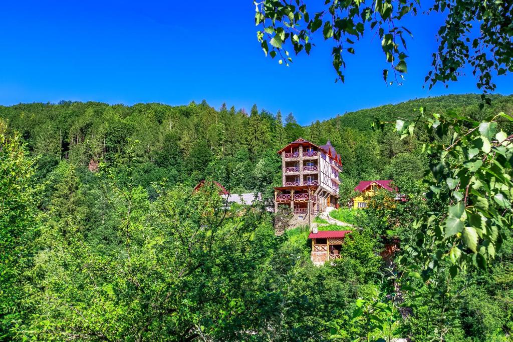 a large building in the middle of a forest at Gutsulska rodzynka in Yaremche