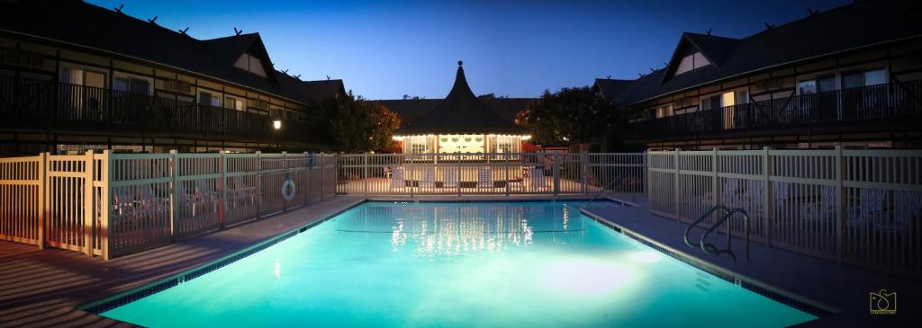 a swimming pool at night with a building in the background at Pea Soup Andersen's Inn in Buellton