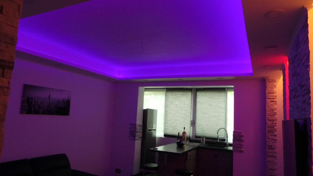 a room with a purple ceiling and a kitchen at Catalans in Marseille