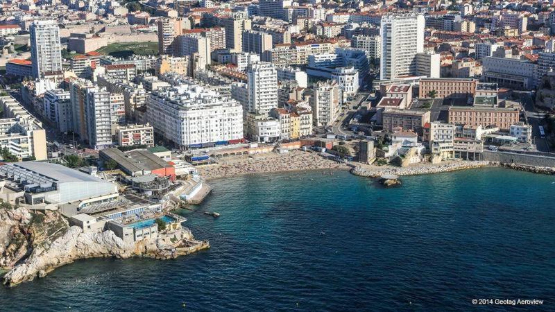 an aerial view of a city and the ocean at Catalans in Marseille