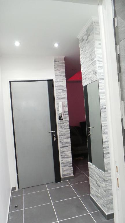 a hallway with a door and a tile floor at Catalans in Marseille