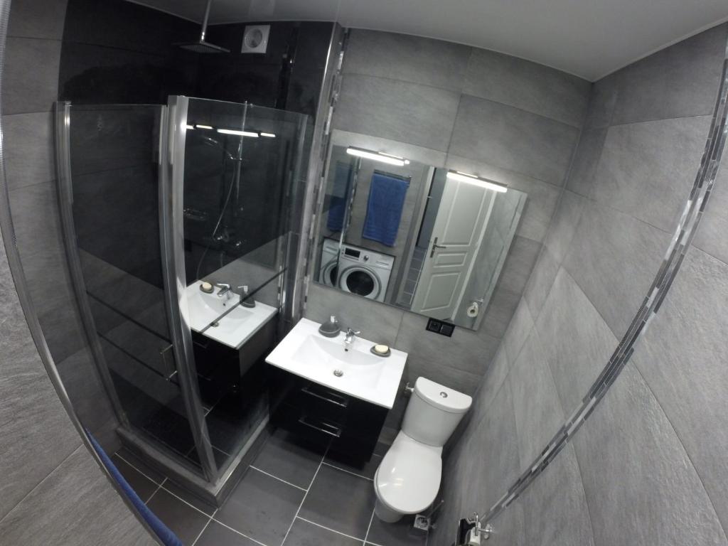 a bathroom with two sinks and a large mirror at Catalans in Marseille