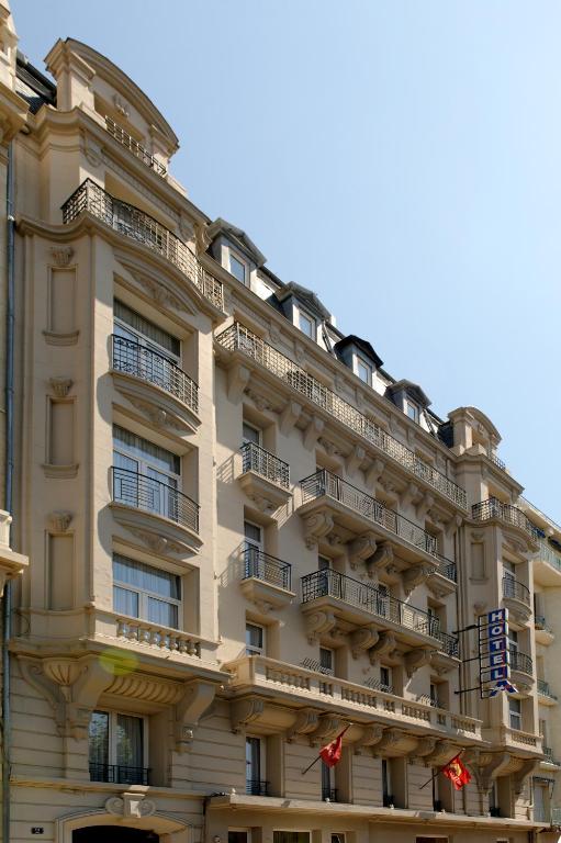 a building with balconies on the side of it at Hôtel Amirauté in Toulon