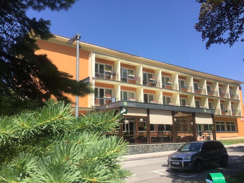 un edificio con un'auto parcheggiata di fronte di Hotel Rezident a Turčianske Teplice